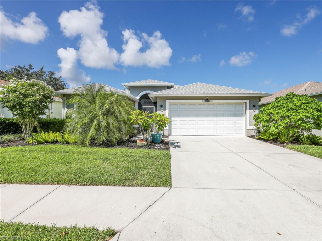 Single-story residential property featuring a light gray exterior, an attached two-car garage, and a concrete driveway