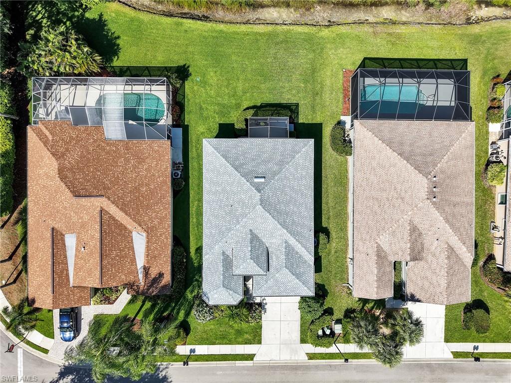 Aerial perspective showcasing three distinct properties, each featuring a private screened pool enclosure