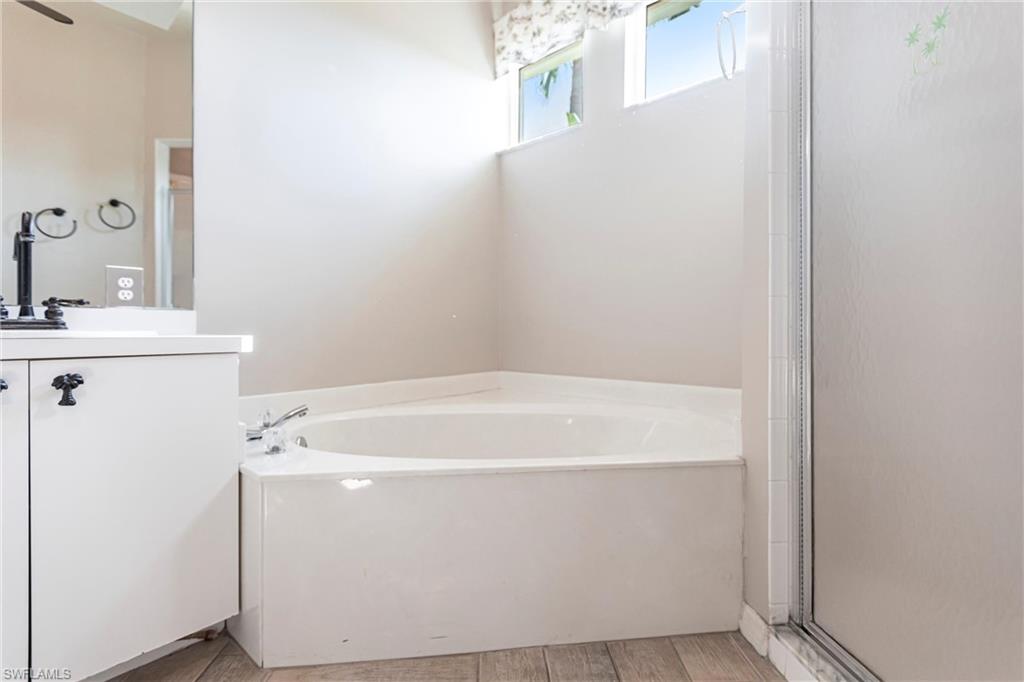 Bathroom featuring vanity, Imported Italian Ceramic tiles, and shower with lovely light coming in from top windows.