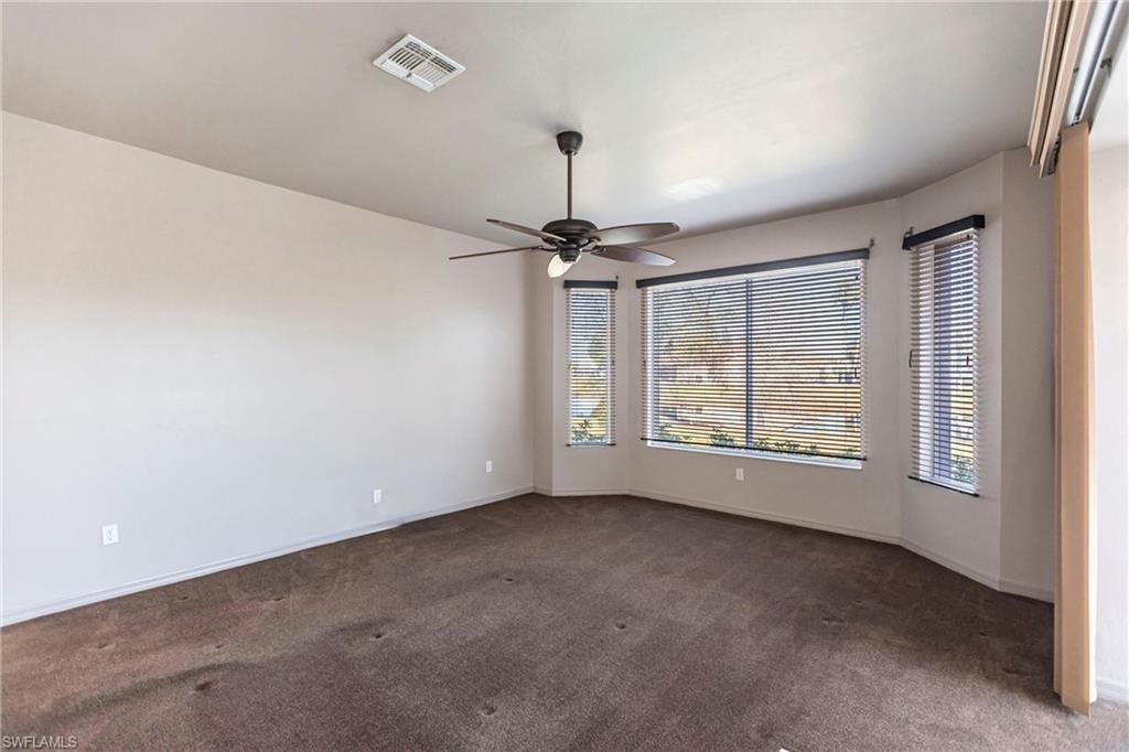 Featuring commercial grade, chocolate carpet and ceiling fan overlooking lake with manual shutters on all three windows
