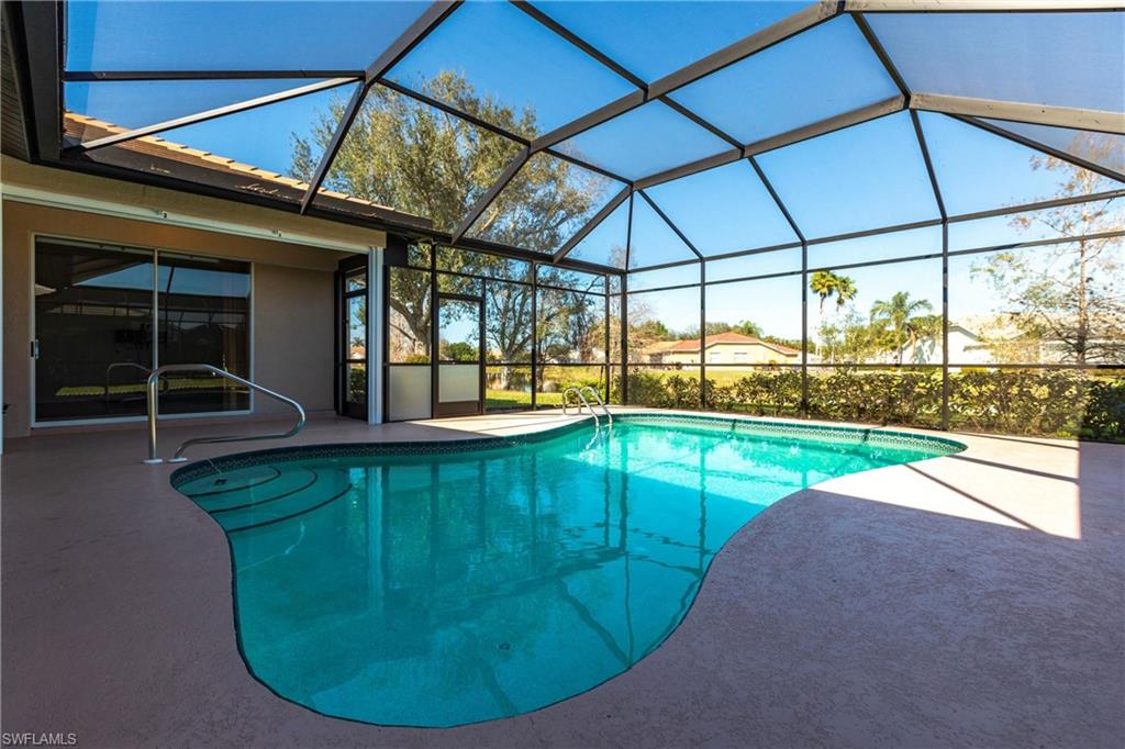 View of swimming pool looking toward lake and entertainment area/kitchen - your little bit of HEAVEN! Freshly painted along with the entire exterior of the house!