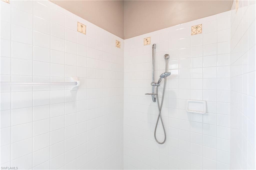 Bathroom with a tile shower.