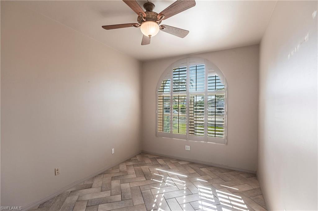 Spacious den/office with custom ceiling fan, interior shutters and hurricane rated windows! The Perfect Home Office or 4th bedroom!
