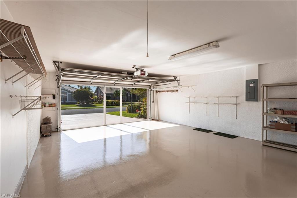Newly epoxied with custom skid-resistant finish, freshly painted expanded (width) garage with shelving. Wonderful pull down screen with door!