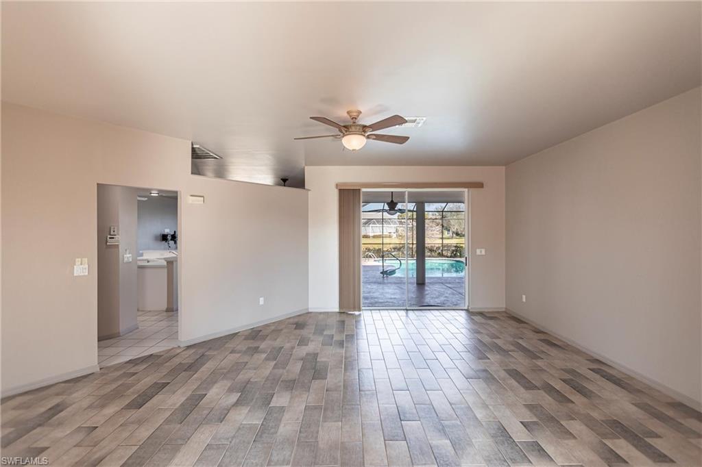 Living room sliders lead to lanai, pool and gorgeous lake view.