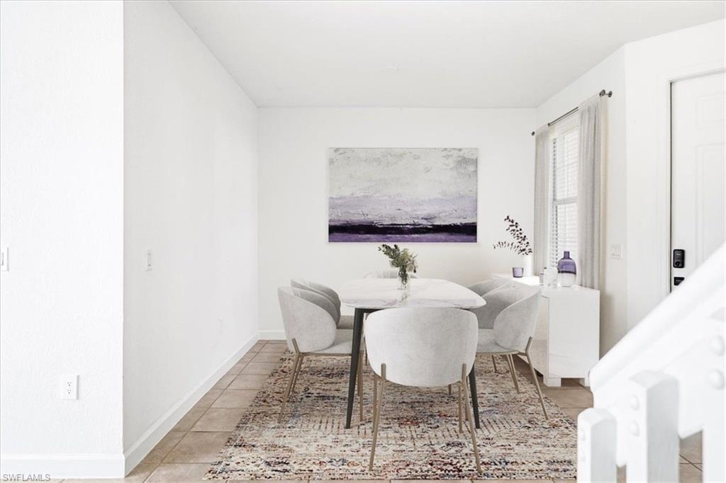 Dining area featuring tile flooring, white walls, a large window with blinds, and a white door with a digital lock