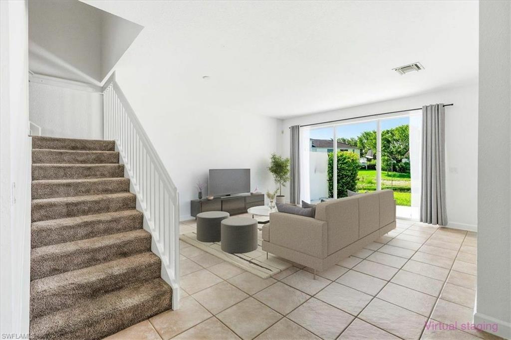 Carpeted staircase with white balusters