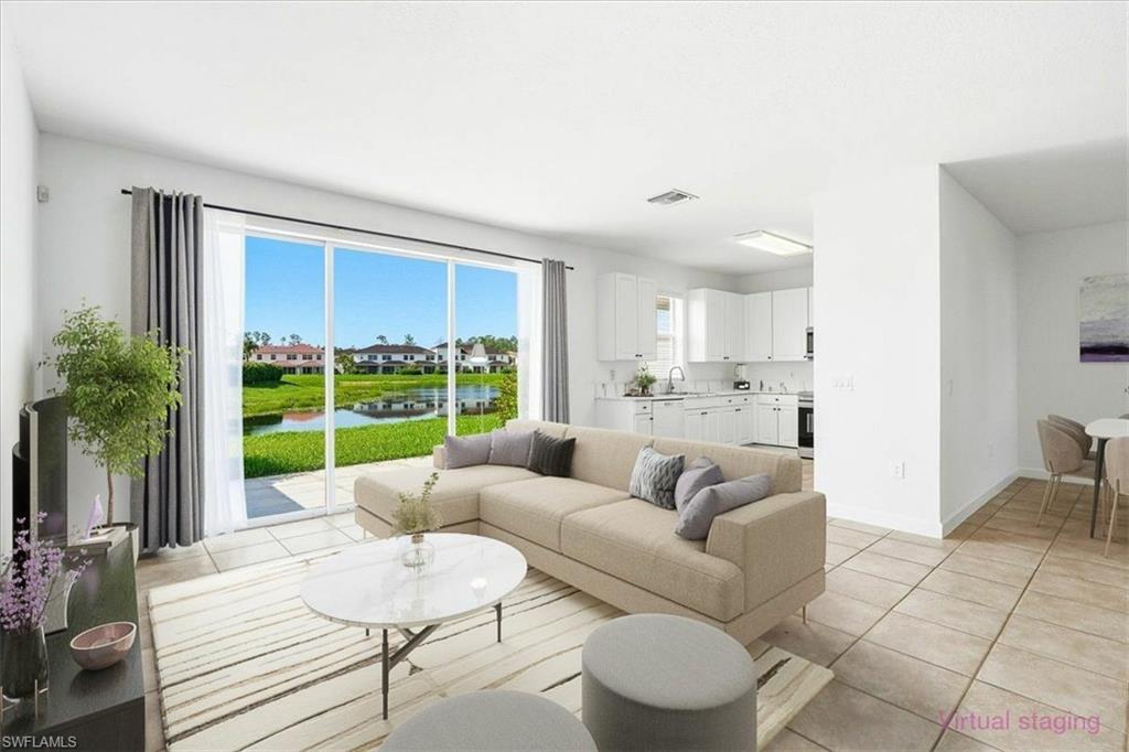 Living space with large sliding glass doors, tile flooring, and white walls