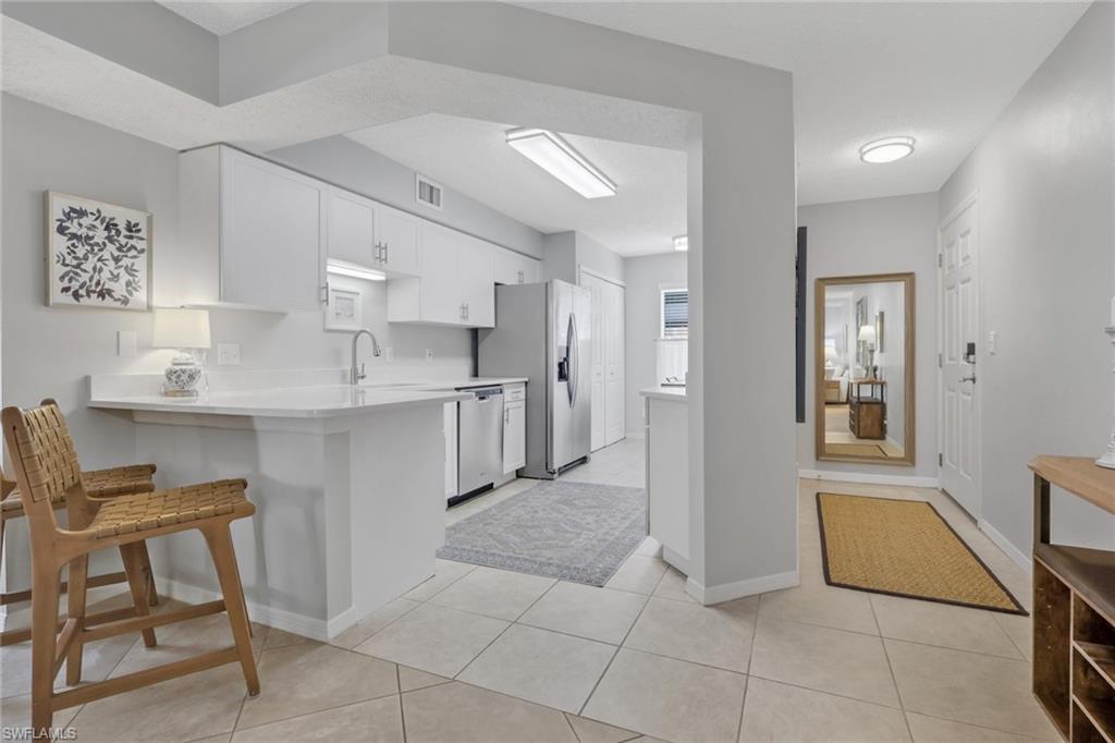 Quartz countertops; entrance to the condo is to the right of the photo