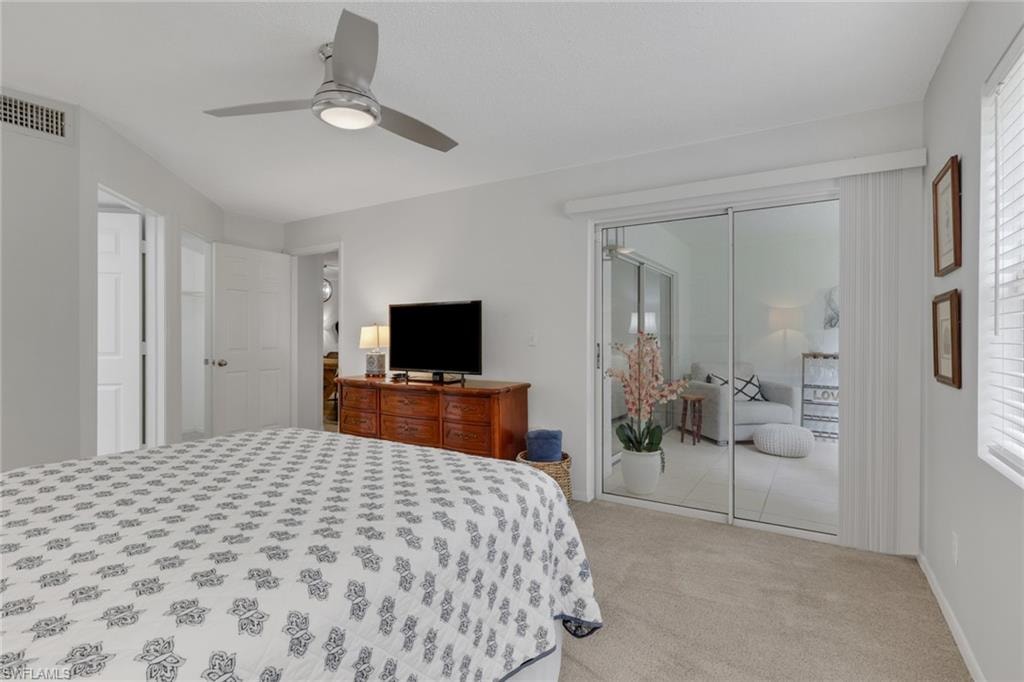 Door to the left leads to the primary bathroom; door just past the bathroom is the walk-in closet; slider doors lead to the enclosed sitting area