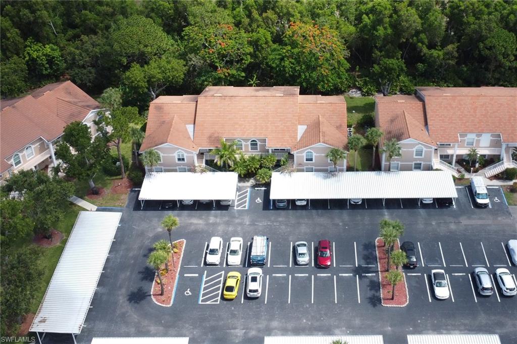 Aerial view of community, showing covered carport; 1 assigned to the condo
