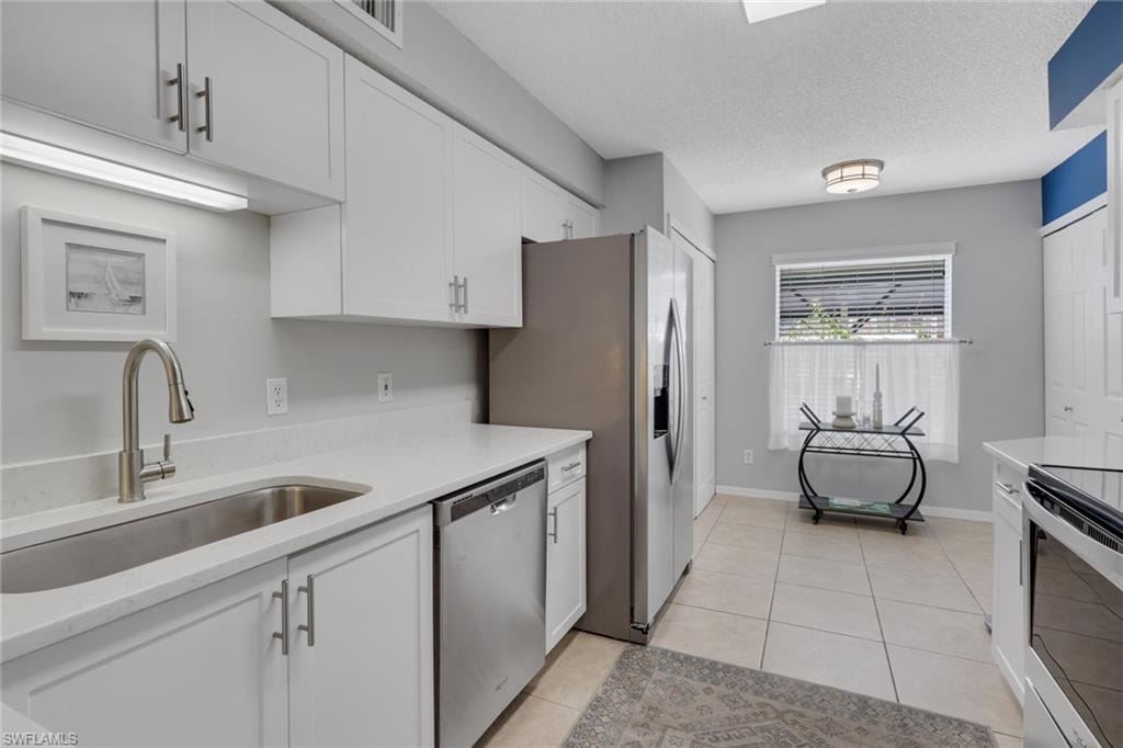 Remodeled with quartz countertops; doors to the left are to the pantry while doors to the right are to the washer and dryer