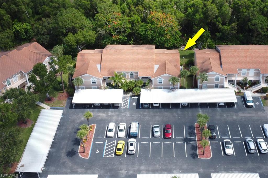 Aerial view of community, showing covered carport; 1 assigned to the condo