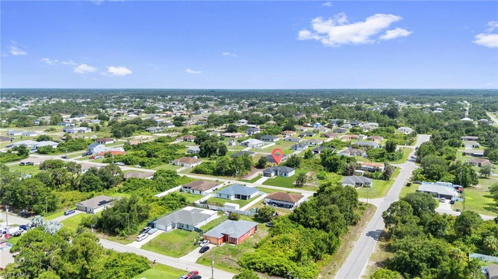 Residential neighborhood featuring single-story homes, mature landscaping, and paved streets