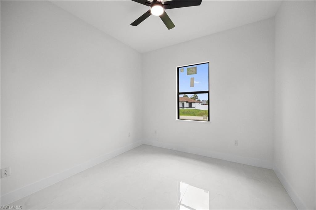 Bright room with white walls, a single rectangular window, and light-toned tile flooring