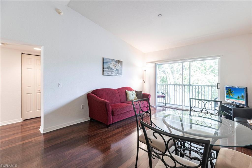 Dining room featuring wood finished floors and high vaulted ceiling