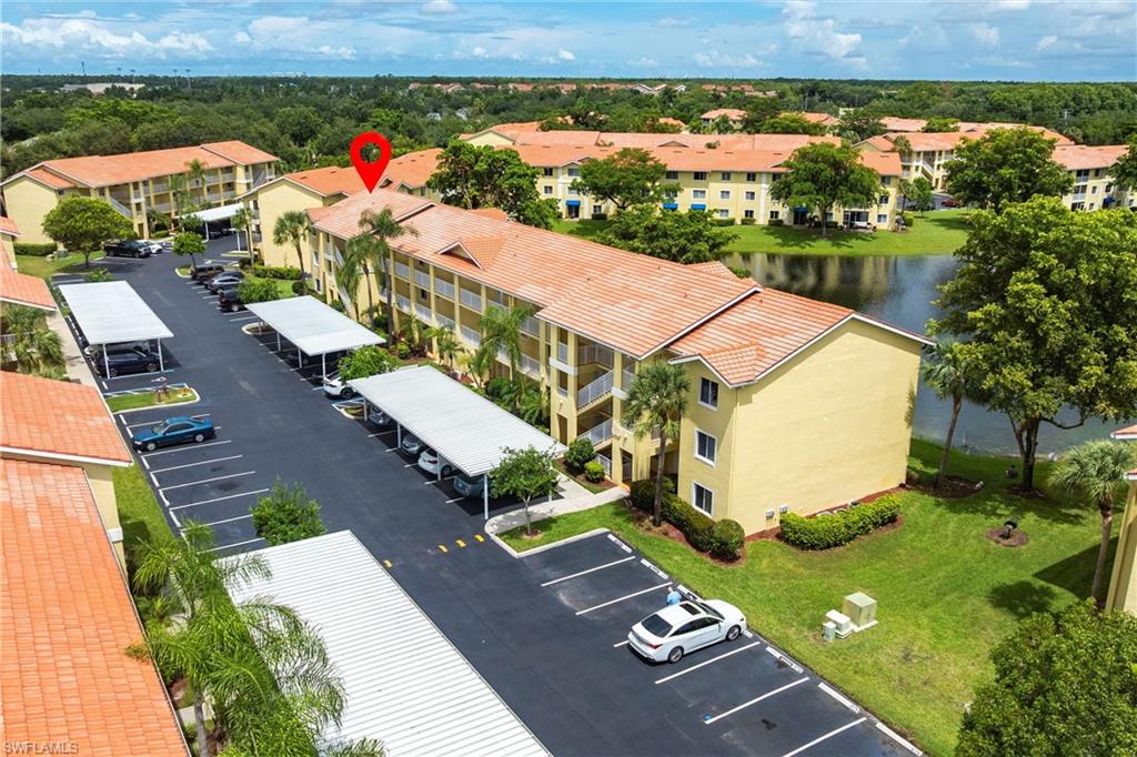 Aerial view of a nearby body of water and apartment complex / building