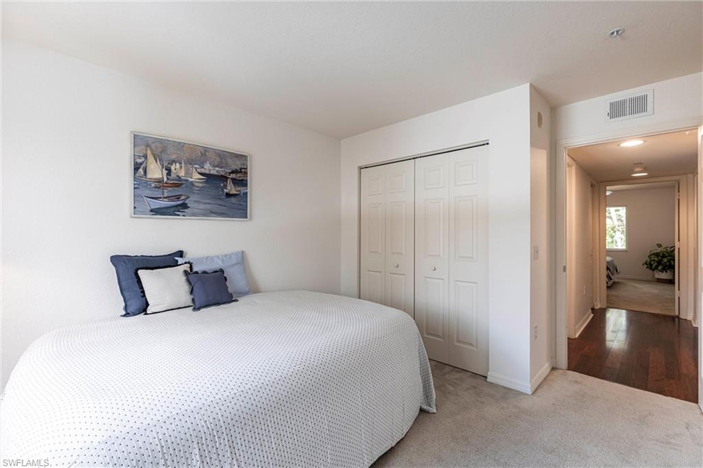Carpeted bedroom with a closet and baseboards