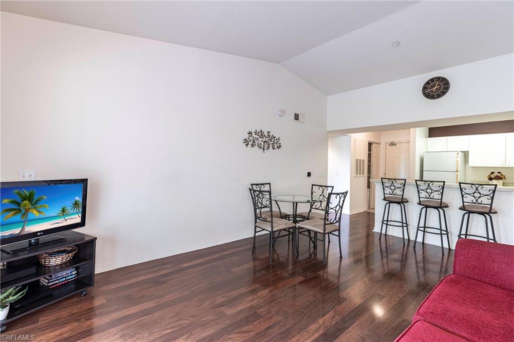 Dining room featuring wood finished floors and lofted ceiling