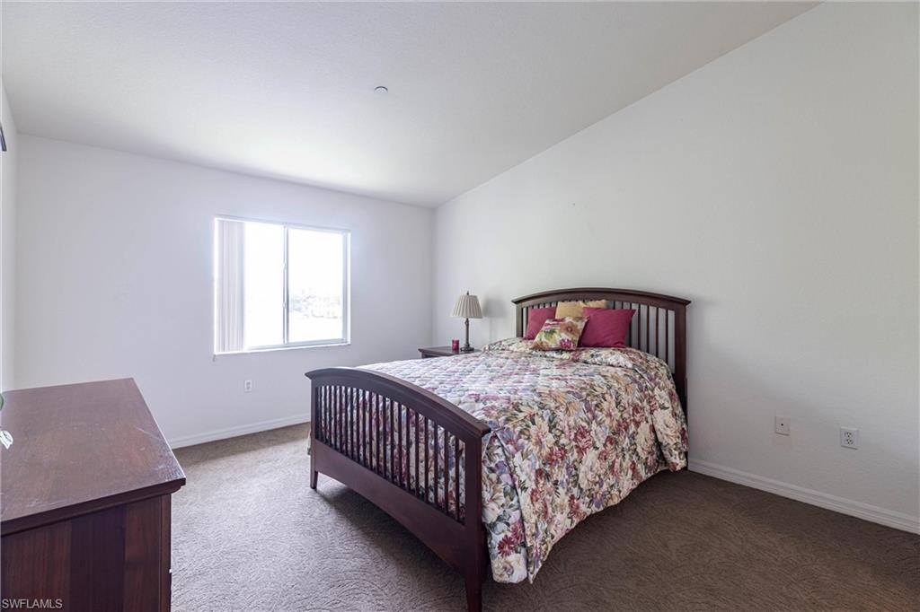 Carpeted bedroom featuring baseboards