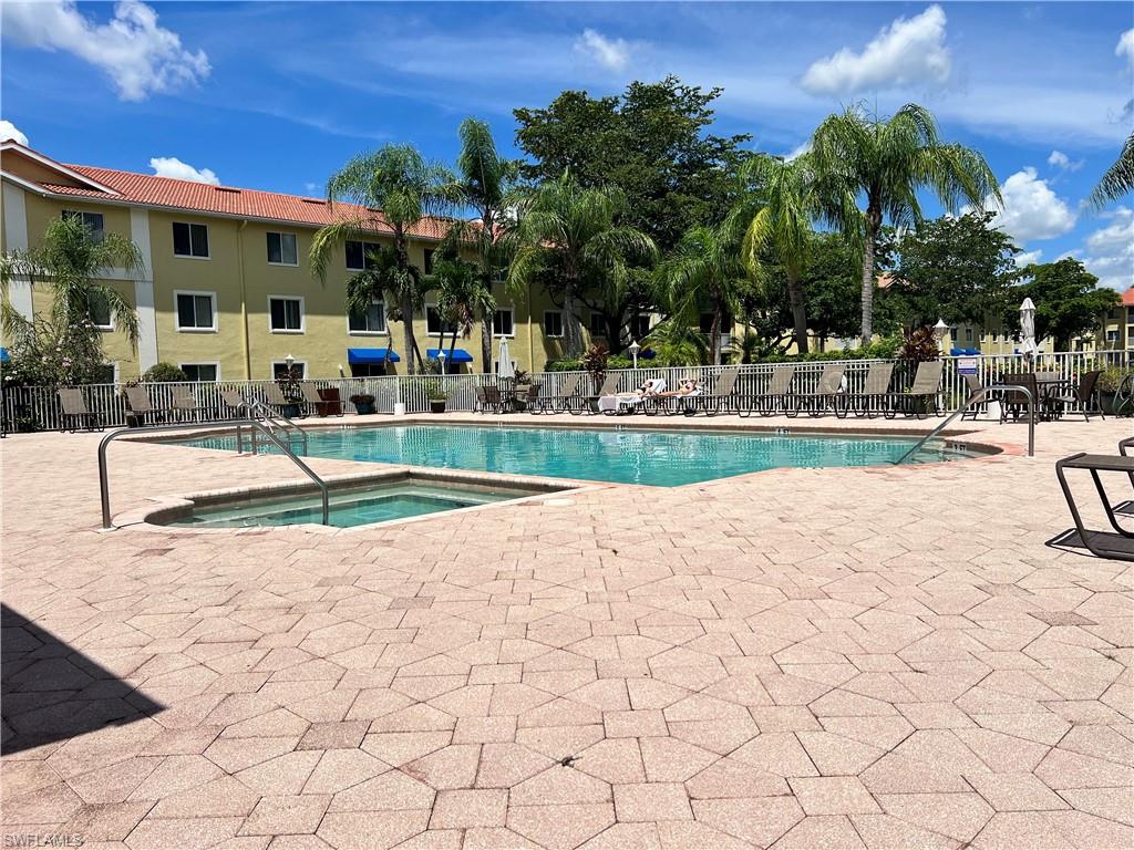 Community pool featuring a community hot tub and a patio