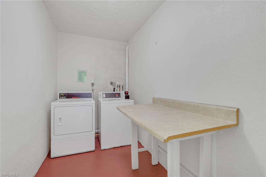 Dedicated laundry area featuring white walls and terracotta-toned flooring