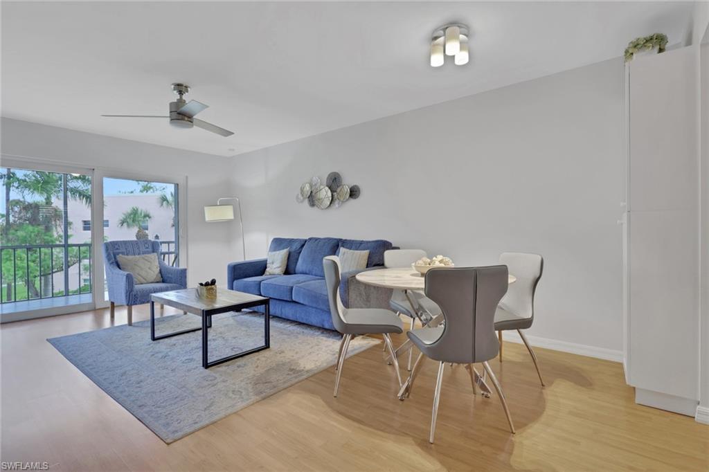 Open-concept living and dining area with light wood-finish flooring