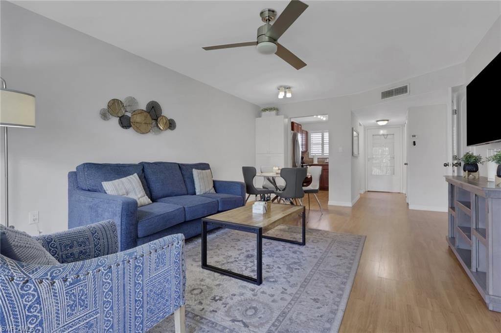Open-concept living area featuring light wood-finish flooring, a contemporary ceiling fan, and recessed lighting