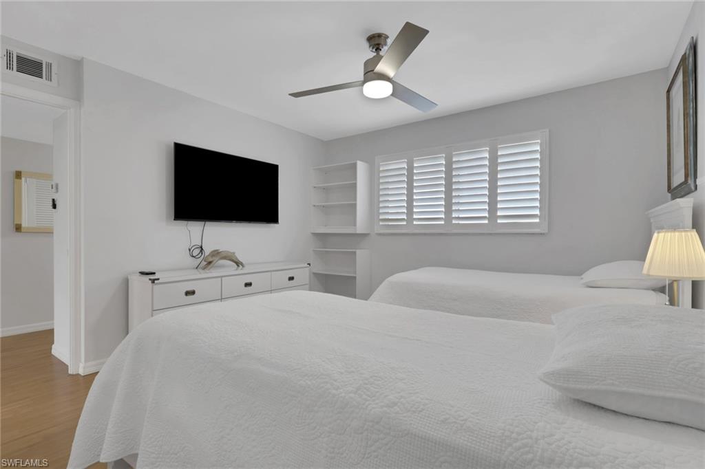 Bright interior space featuring a window with white plantation shutters