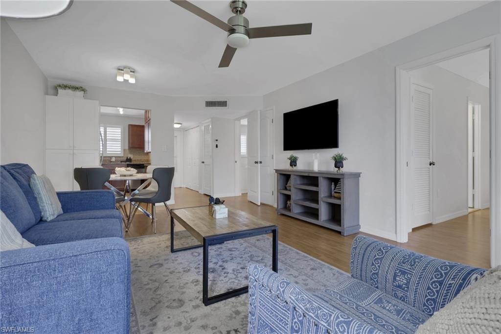 Open-concept living space with wood-finish flooring