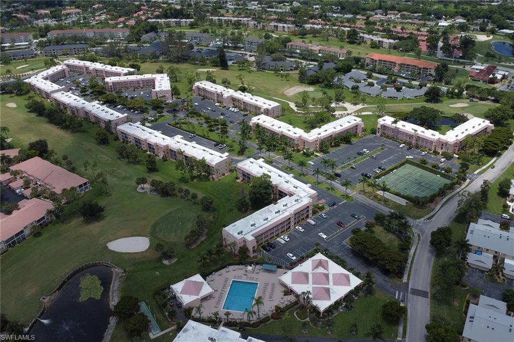 Expansive aerial view showcasing residential buildings with golf course frontage