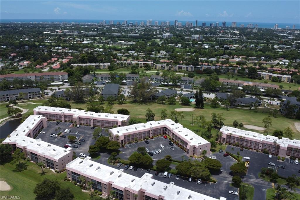 Aerial perspective showcasing a multi-building residential complex with ample parking