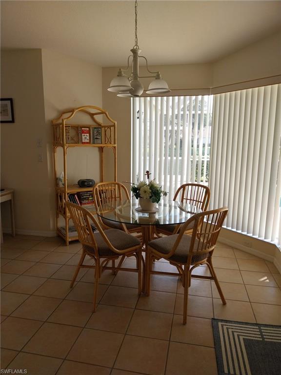 Dining area featuring a chandelier and light tile patterned flooring