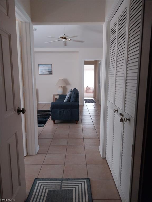 Hall featuring light tile patterned floors