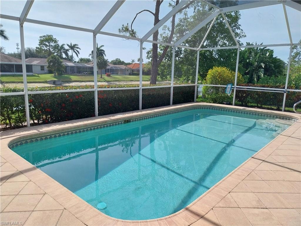 Swimming pool with a lanai and a residential view