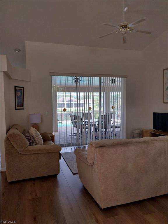 Living area featuring wood finished floors and a ceiling fan