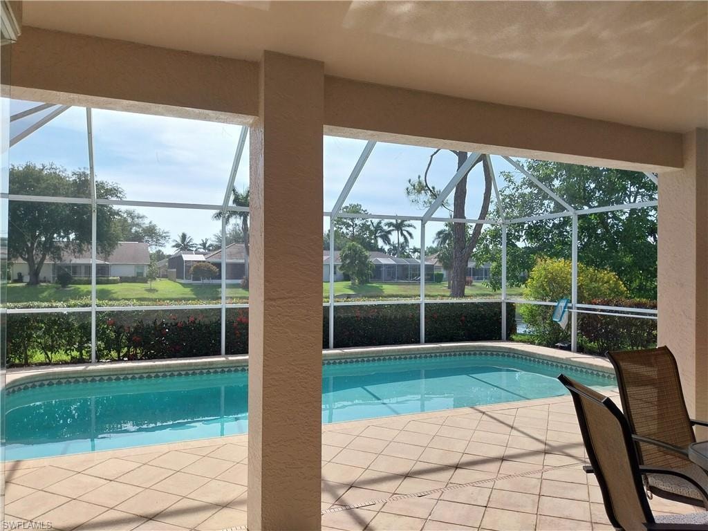 Outdoor pool with glass enclosure and a patio area