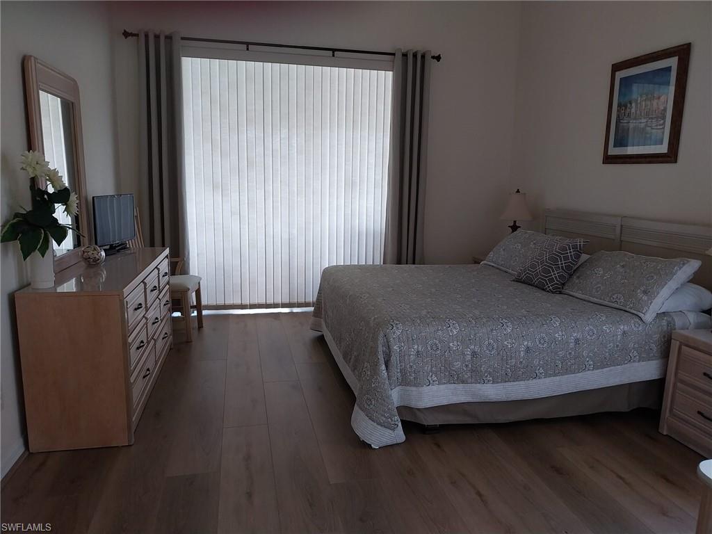 Bedroom with dark wood-style floors