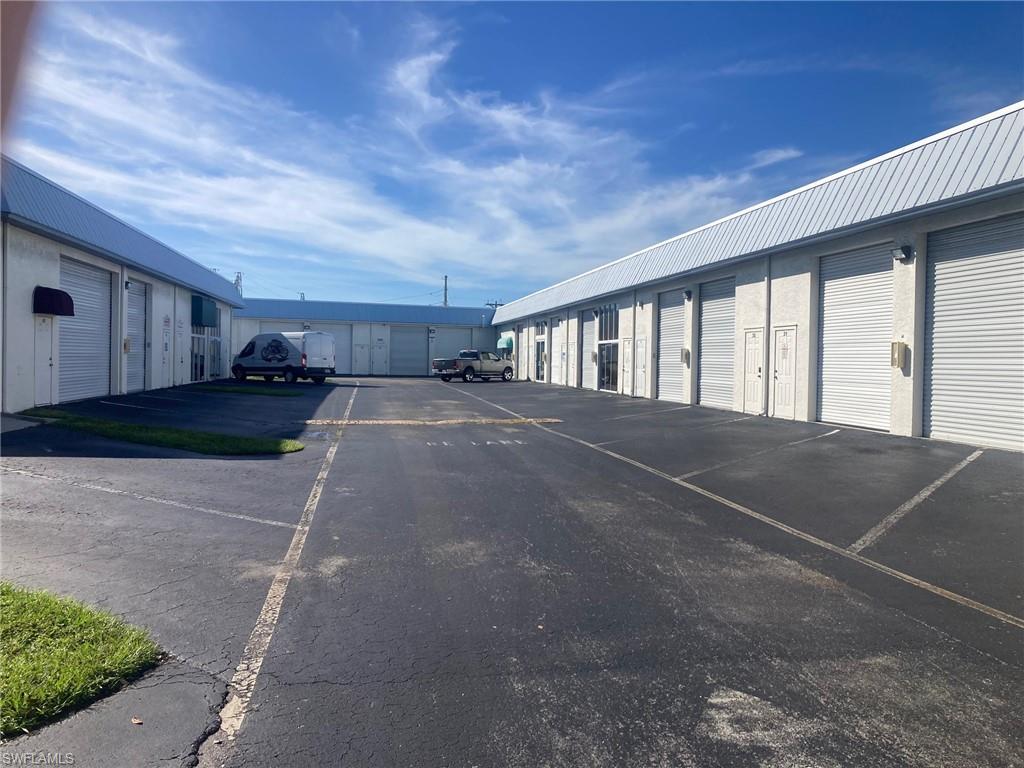 View of parking / parking lot with community garages