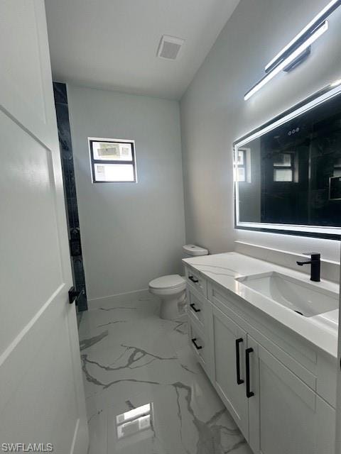 Bathroom featuring light marble finish flooring and vanity