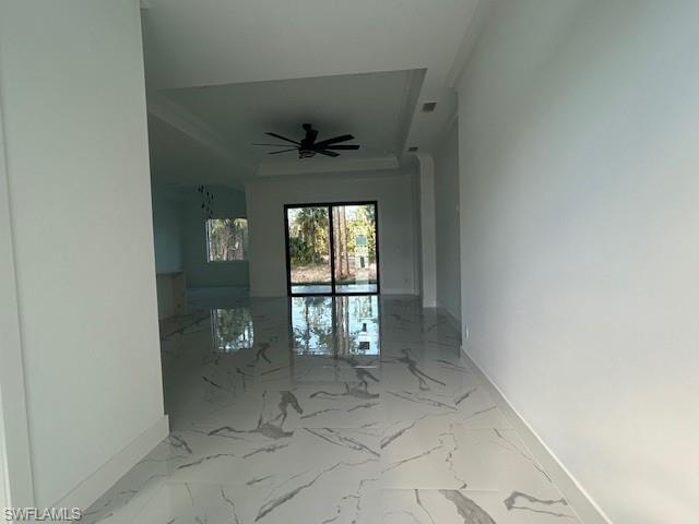 Spare room with light marble finish floors and ceiling fan