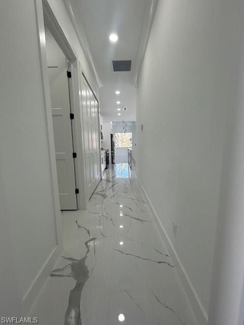 Corridor with recessed lighting and light marble finish flooring
