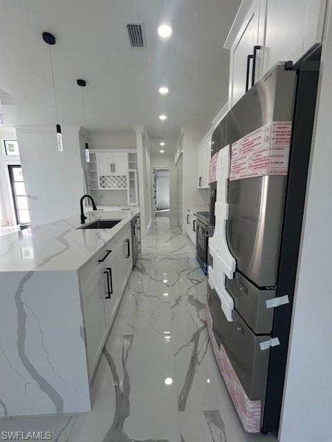 Kitchen with white cabinetry, open shelves, recessed lighting, light marble finish flooring, and fridge