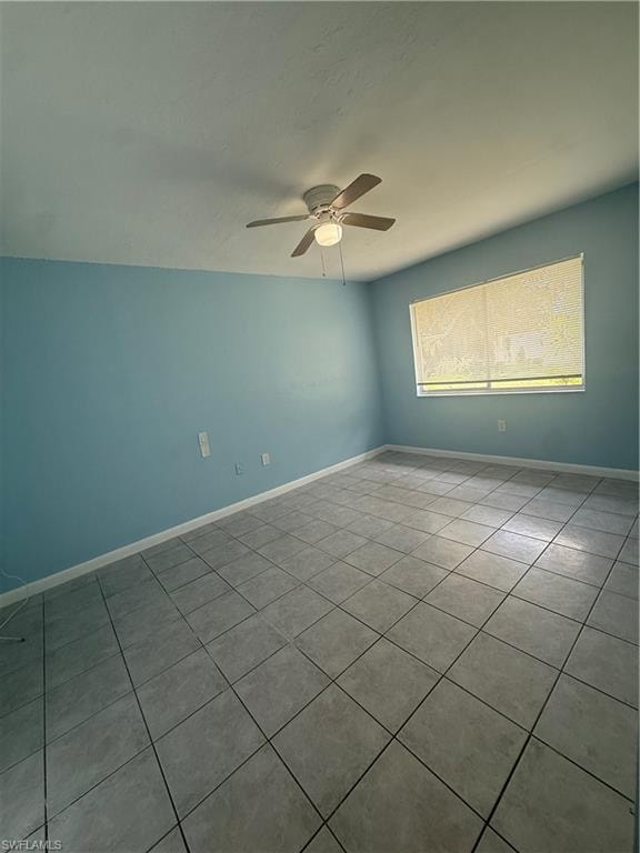 Spacious room featuring tile flooring, a ceiling fan with integrated lighting, and a window with horizontal blinds