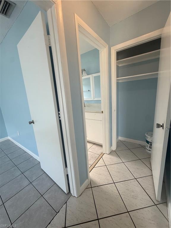 Tiled flooring throughout with a distinct pattern in the main area