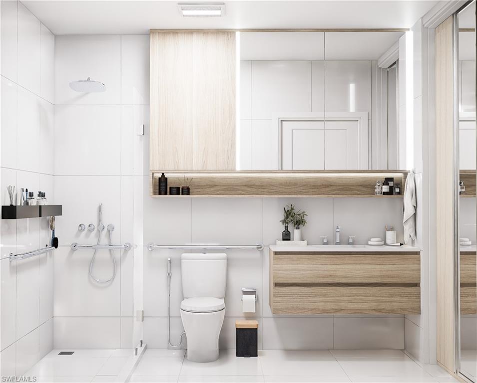 Bathroom with a shower stall, vanity, and light tile patterned floors