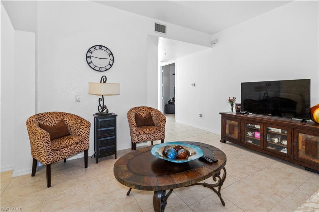 Sitting room featuring light tile patterned flooring and baseboards