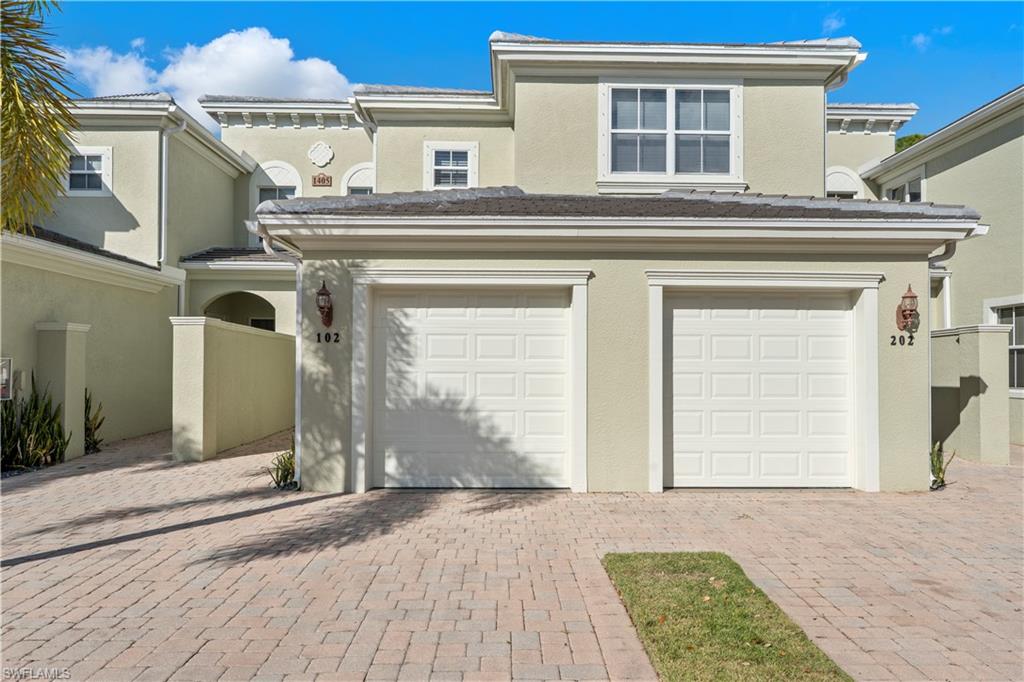 Garage featuring decorative driveway