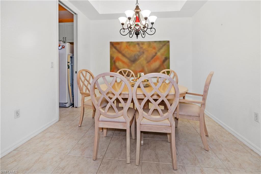 Dining area featuring a chandelier and light tile patterned flooring