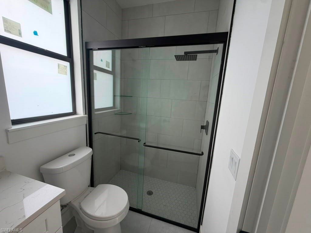 Shower enclosure with clear glass doors and matte black framing